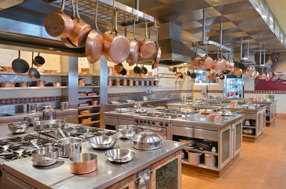 Professional commercial kitchen with stainless steel stations and equipment